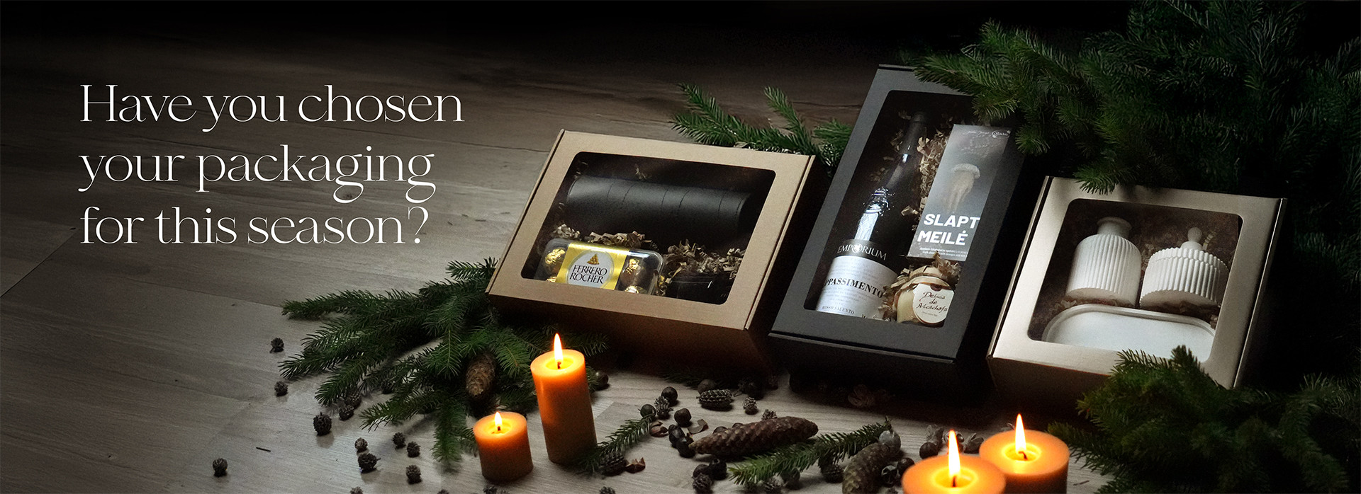 Three elegantly packaged gift boxes with candles and pine decorations, accompanied by the text: "Have you chosen your packaging for this season?"